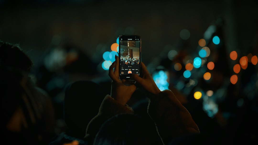 person using smartphone in crowd